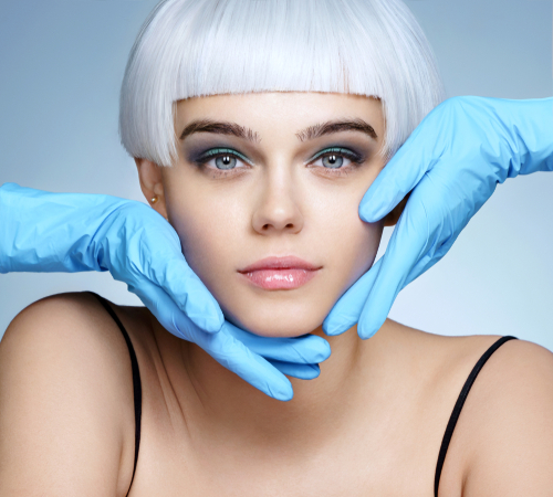 doctors hands in gloves touching face of beautiful woman in blond wig-img-blog